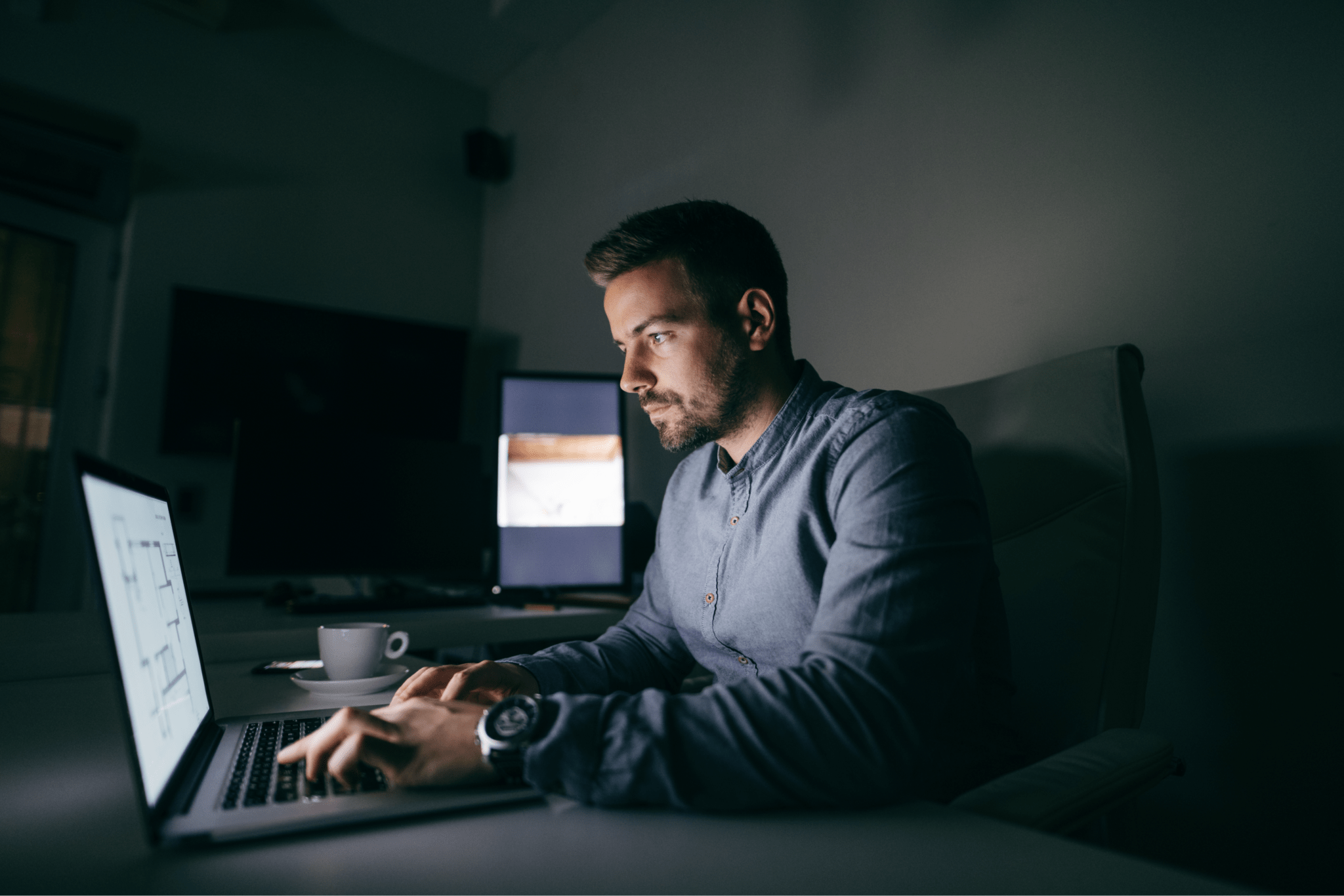 young-caucasian-worker-typing-laptop-while-sitting-office-late-night-1-1765552912